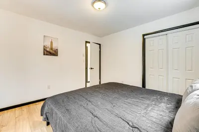 a bedroom with a bed and a white door at Hot Tub and Game Room Long Pond Getaway! in Long Pond