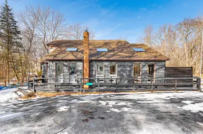 an old house in the middle of the street at Hot Tub and Game Room Long Pond Getaway! in Long Pond