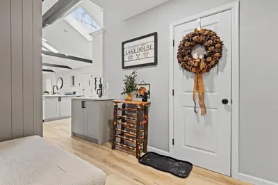 a kitchen with a white door and a wreath at NewReno 8BR 6BTH DECK GAMES PETS in Lake Harmony