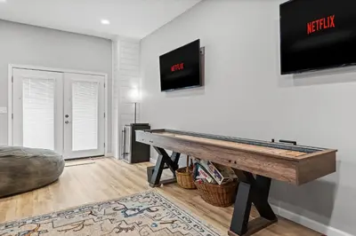 a living room with a ping pong table and a flat screen tv at NewReno 8BR 6BTH DECK GAMES PETS in Lake Harmony