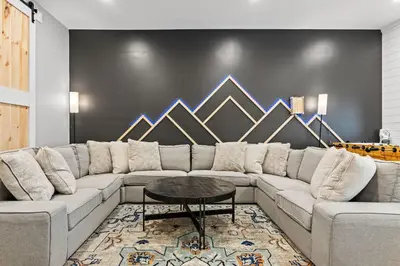 a living room with a large couch and a table at NewReno 8BR 6BTH DECK GAMES PETS in Lake Harmony
