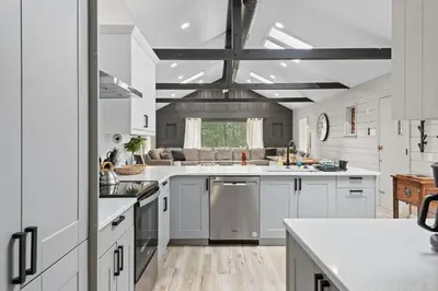 a kitchen with white cabinets and white counters at NewReno 8BR 6BTH DECK GAMES PETS in Lake Harmony