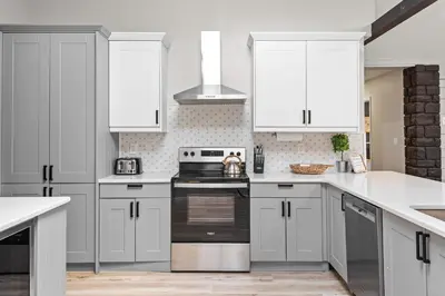 a kitchen with white cabinets and a stove top oven at NewReno 8BR 6BTH DECK GAMES PETS in Lake Harmony