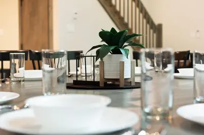 a table with glasses and a potted plant on it at Twin Chalet 6 BDs Hot Tub Game Area and more in Albrightsville
