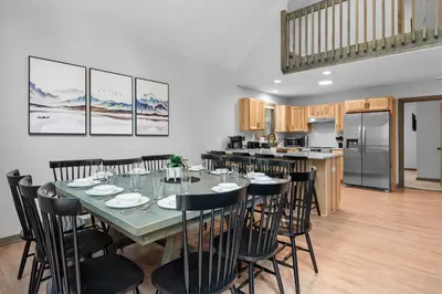 a dining room and kitchen with a table and chairs at Twin Chalet 6 BDs Hot Tub Game Area and more in Albrightsville