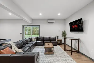 a living room with a couch and a table at Twin Chalet - 6 BDs Hot Tub Game Area and more in Albrightsville
