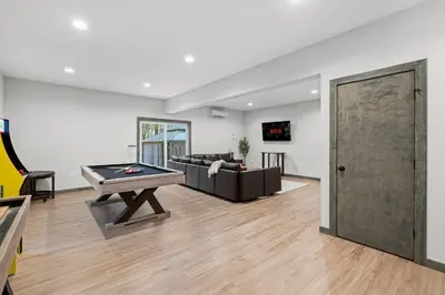 a living room with a couch and a ping pong table at Twin Chalet - 6 BDs Hot Tub Game Area and more in Albrightsville