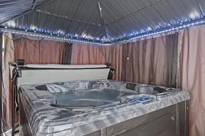 a tub in a tent with a bed in it at Twin Chalet - 6 BDs Hot Tub Game Area and more in Albrightsville
