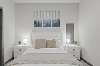 a white bedroom with a white bed and two night stands at Twin Chalet - 6 BDs Hot Tub Game Area and more in Albrightsville