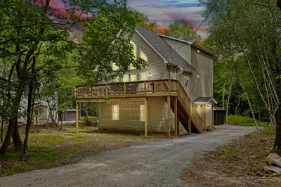 a house with a deck on the side of a road at Twin Chalet - 6 BDs Hot Tub Game Area and more in Albrightsville