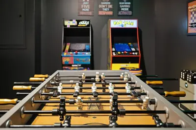 a row of arcade games in a gaming room at Lakefront Movie & Game Rooms Hot Tub Sauna etc in Albrightsville