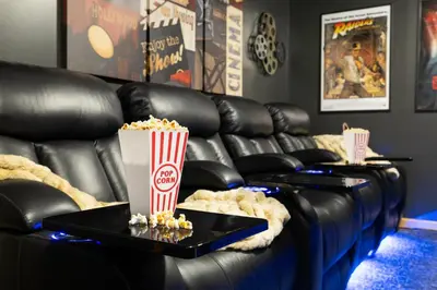 a leather couch with popcorn and a box of popcorn at Lakefront Movie & Game Rooms Hot Tub Sauna etc in Albrightsville