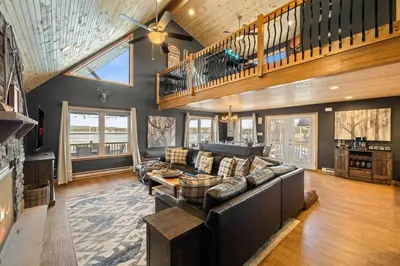 a living room with a couch and a table at Lakefront Movie & Game Rooms Hot Tub Sauna etc in Albrightsville