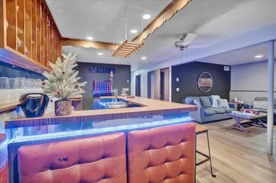a kitchen with a bar and a living room at Mountain Holidays-Sleeps 18 Firepit Bar & Gameroom in Lake Harmony