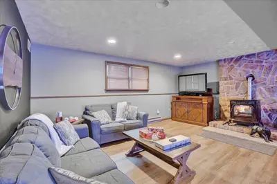 a living room with a couch and a fireplace at Mountain Holidays-Sleeps 18 Firepit Bar & Gameroom in Lake Harmony
