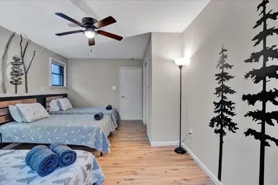 a bedroom with two beds and a ceiling fan at Mountain Holidays-Sleeps 18 Firepit Bar & Gameroom in Lake Harmony