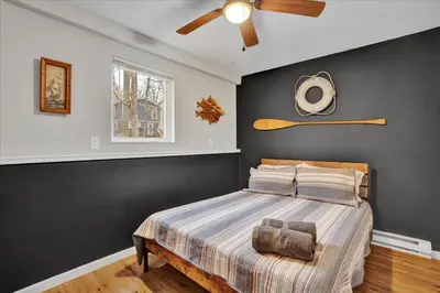a bedroom with a bed and a ceiling fan at Mountain Holidays-Sleeps 18 Firepit Bar & Gameroom in Lake Harmony