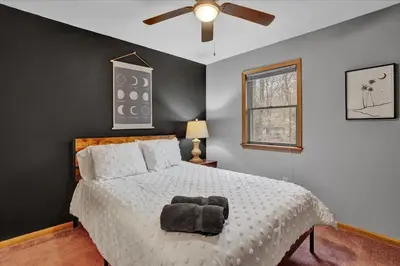 a bedroom with a bed and a ceiling fan at Mountain Holidays-Sleeps 18 Firepit Bar & Gameroom in Lake Harmony