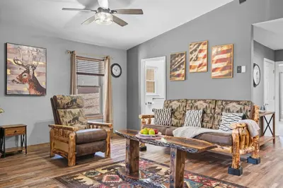a living room with a couch and a table at Cabin Oasis - Nestled in the Woods Seclusion in Blakeslee