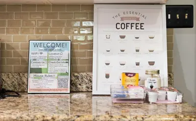 a counter with two signs and some food on it at Cabin Oasis - Nestled in the Woods Seclusion in Blakeslee