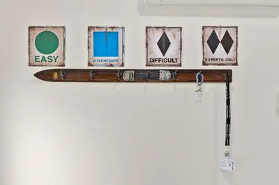 a shelf with four pictures on a wall at The Cozy Cubhouse Perfect Couples Getaway in Thornhurst