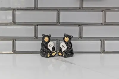 two black bear figurines with the letters s on them at The Cozy Cubhouse Perfect Couples Getaway in Thornhurst