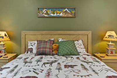 a bedroom with a bed with a blanket with animals on it at The Cozy Cubhouse Perfect Couples Getaway in Thornhurst