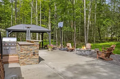 a backyard with a grill and a gazebo at The Cozy Cubhouse Perfect Couples Getaway in Thornhurst