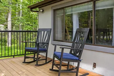 two chairs sitting on a porch next to a window at The Cozy Cubhouse Perfect Couples Getaway in Thornhurst
