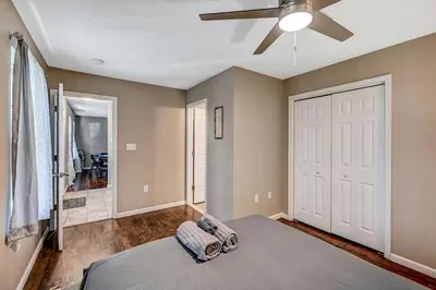 a bedroom with a bed and a ceiling fan at Spacious Retreat - Outdoor Oasis Games and more in Blakeslee