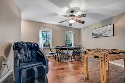 a living room with a table and a chess board at Spacious Retreat - Outdoor Oasis Games and more in Blakeslee