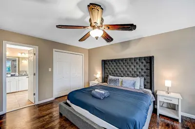 a bedroom with a bed and a ceiling fan at Spacious Retreat - Outdoor Oasis Games and more in Blakeslee