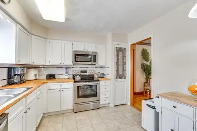 a kitchen with white cabinets and stainless steel appliances at Peaceful 1-Acre Parksville Home Large Deck and Yard in Parksville