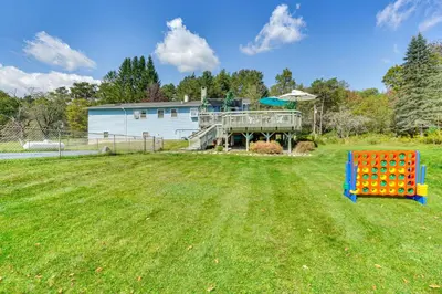 a yard with a playground and a house at Peaceful 1-Acre Parksville Home Large Deck and Yard in Parksville