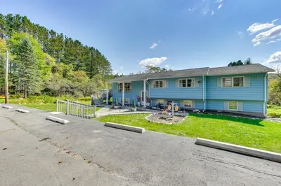 a blue house with a driveway in front of it at Peaceful 1-Acre Parksville Home Large Deck and Yard in Parksville