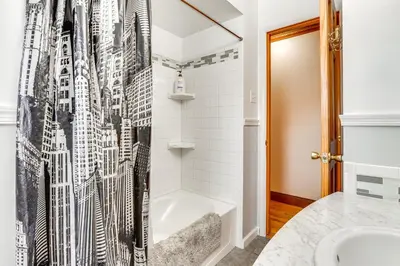 a bathroom with a bath tub and a shower curtain at Peaceful 1-Acre Parksville Home Large Deck and Yard in Parksville