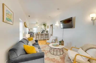 a living room with a couch and a table at Walk to Beach Keansburg Home with Patio and Fire Pit! in Keansburg
