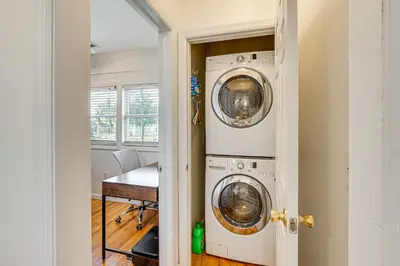 a laundry room with two washer and dryer at Walk to Beach Keansburg Home with Patio and Fire Pit! in Keansburg