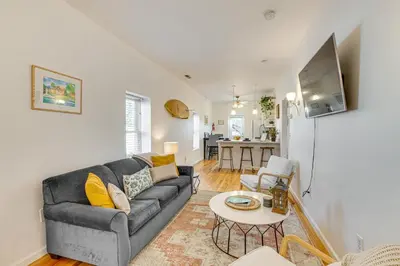 a living room with a couch and a table at Walk to Beach Keansburg Home with Patio and Fire Pit! in Keansburg