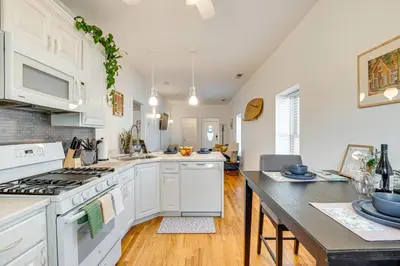 a kitchen with white cabinets and a counter top at Walk to Beach Keansburg Home with Patio and Fire Pit! in Keansburg