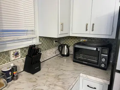 a kitchen counter with a microwave on top of it at Waterfront 4BR apt - 15Min to MetLife and TIMES SQ in Union City