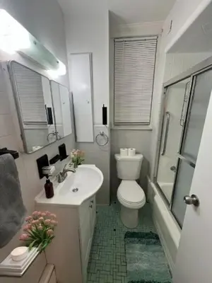 a bathroom with a toilet and a sink and a shower at Waterfront 4BR apt - 15Min to MetLife and TIMES SQ in Union City