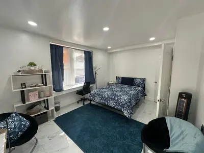 a bedroom with a bed and a window at F and R property in Philadelphia