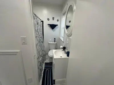 a small bathroom with a sink and a mirror at F and R property in Philadelphia