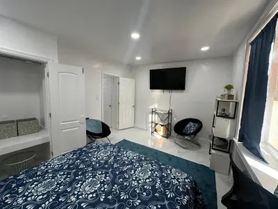 a bedroom with a bed and a flat screen tv at F and R property in Philadelphia