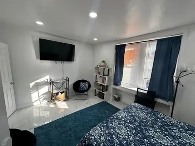 a bedroom with a bed and a flat screen tv at F and R property in Philadelphia