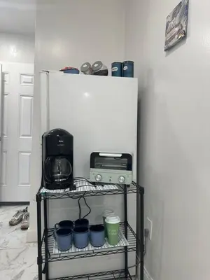 a shelf with a toaster and a radio in a room at F and R property in Philadelphia