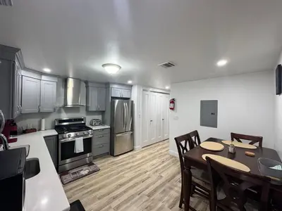 a kitchen with a table and a stove top oven at Luxury Modern Apt near NYC for 4 people in Jersey City