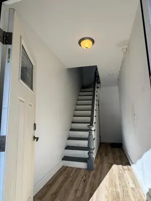a staircase in a house with a white wall at Luxury Modern Apt near NYC for 4 people in Jersey City
