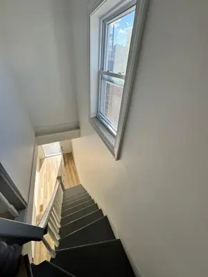 a stairway with a window and a stair case at Luxury Modern Apt near NYC for 4 people in Jersey City